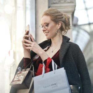 Woman Standing Near Wall Holding Phone